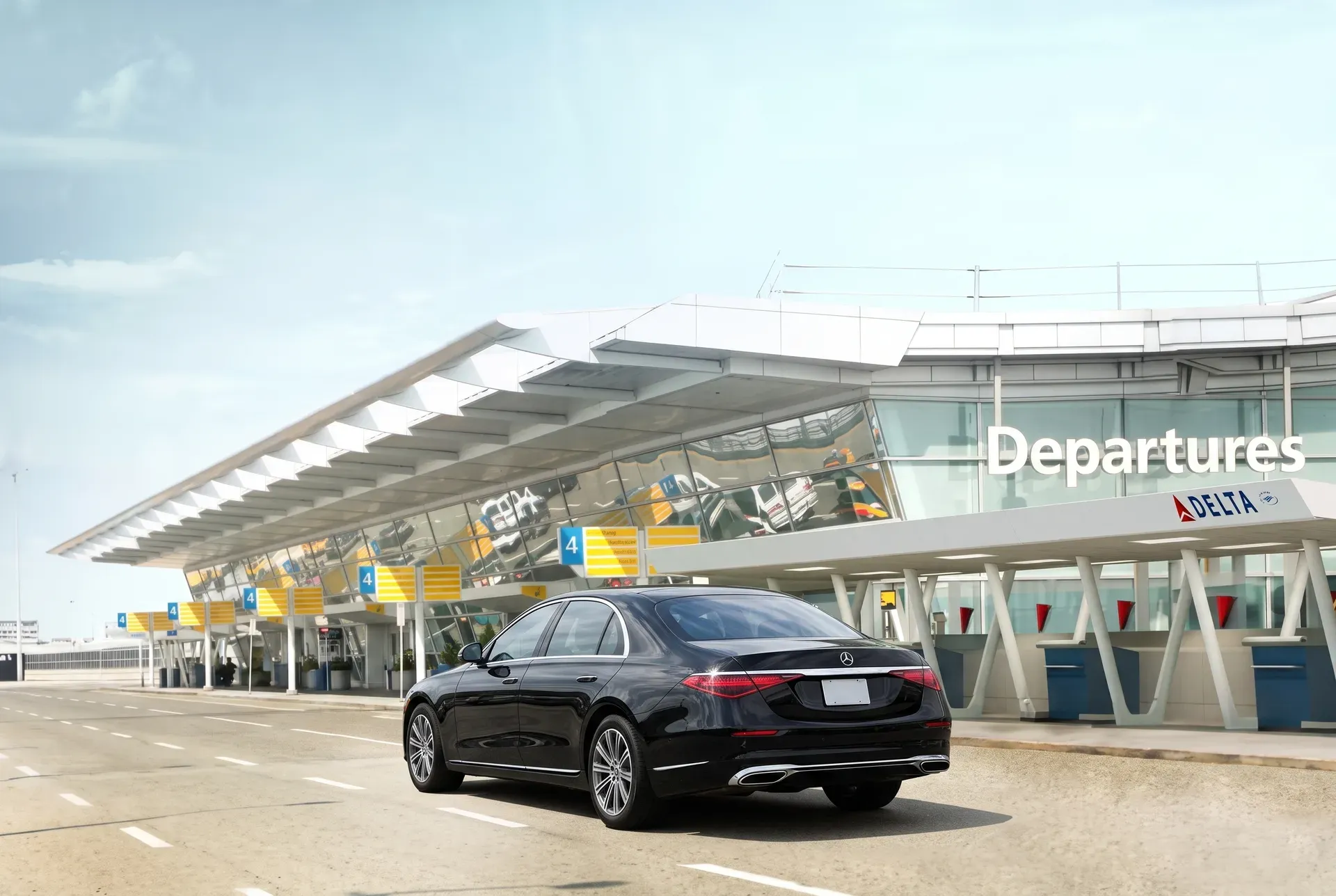 Black Mercedes-Benz S-Class chauffeur car parked at the JFK Terminal 4 Departures curb