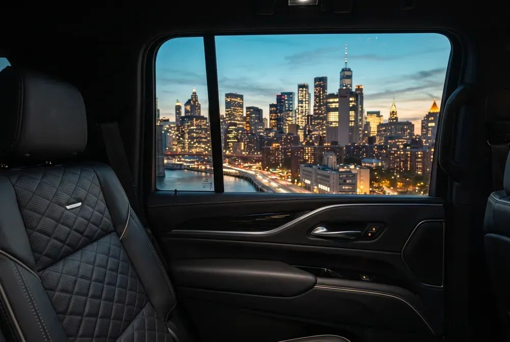 Manhattan skyline at dusk seen from the rear cabin of a chauffeur-driven vehicle